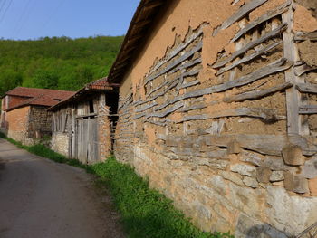 Graffiti on wall of old building against sky