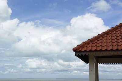 Low angle view of house by sea against sky