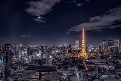 Illuminated cityscape against sky at night