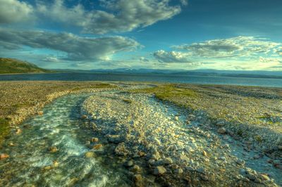 Scenic view of sea against cloudy sky