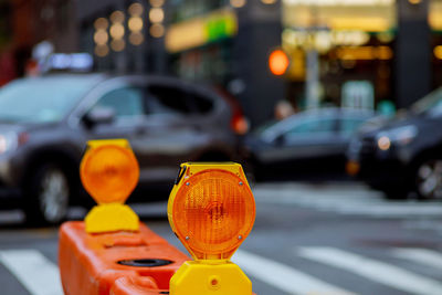 Close-up of yellow traffic on road in city