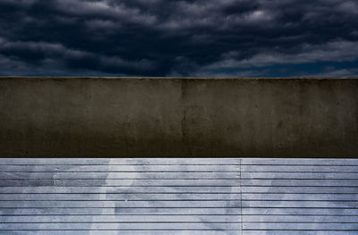 High section of wall against cloudy sky
