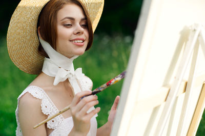 Portrait of smiling woman wearing hat