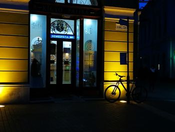 Illuminated entrance of building in city at night