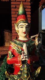 Close-up of statue against temple outside building