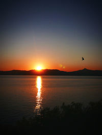 Scenic view of lake against sky during sunset