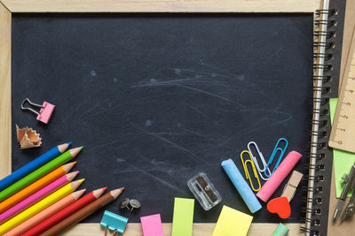 Close-up of blackboard with school supplies