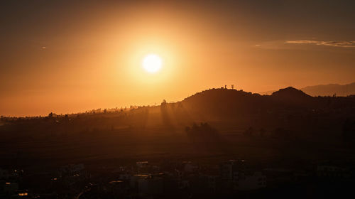 Scenic view of silhouette mountains against sky during sunset