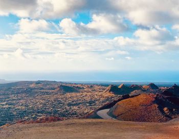 Scenic view of landscape and sea against sky