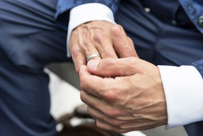 Midsection of bride holding hands