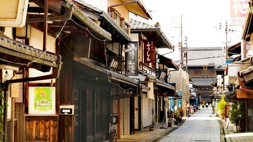 Street amidst buildings in city against clear sky