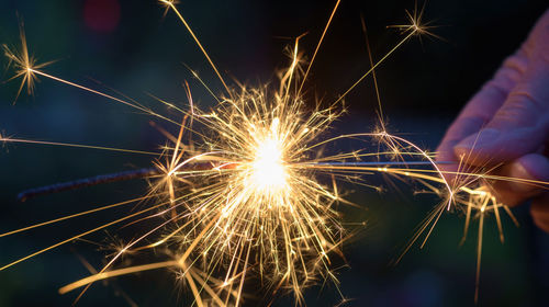 Low angle view of firework display at night