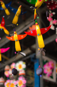 Close-up of multi colored decoration hanging for sale in market