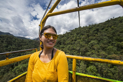 Woman taking a cable car ride at the waterfall in mindo, ecuador