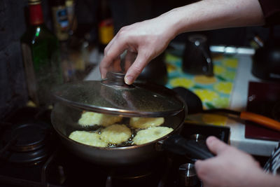 Midsection of person preparing food in kitchen