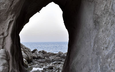 Scenic view of sea seen through cave