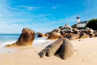 Panoramic view of rocks on beach against sky