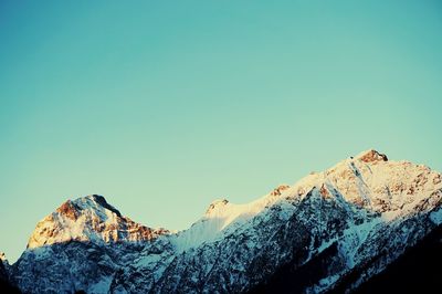 Scenic view of snowcapped mountains against clear blue sky