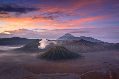 View of volcanic landscape against cloudy sky