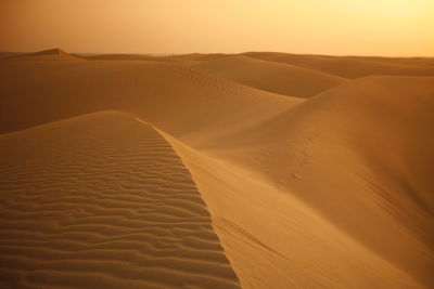 Scenic view of sand dunes at desert against sky