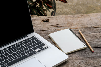 High angle view of laptop and book on table