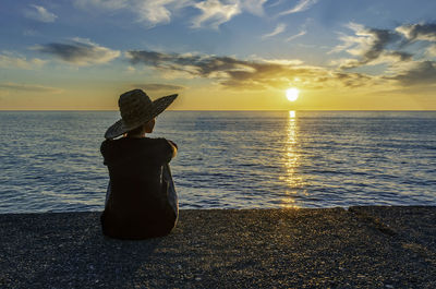 Girl in a hat by the sea