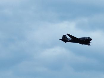 Low angle view of airplane flying in sky