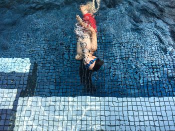 High angle view of boy swimming in pool