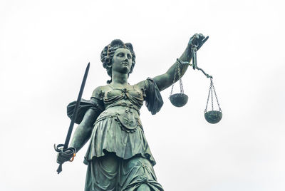 Low angle view of statue against sky