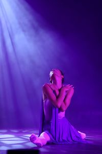 Woman sitting on purple flesh