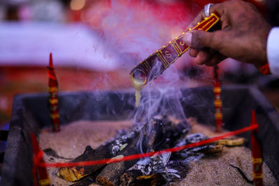 Cropped hand of man doing religious ceremony of marriage 