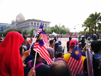 Group of people on street against buildings