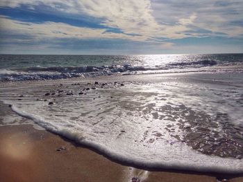 Scenic view of sea against cloudy sky