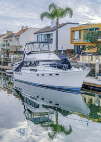 Boats moored in water against buildings