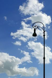 Low angle view of street light against cloudy sky