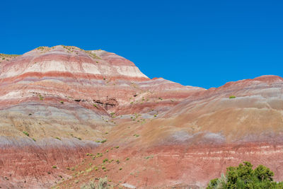 Scenic view of mountains against clear blue sky