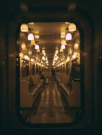 Illuminated subway station platform seen through train window
