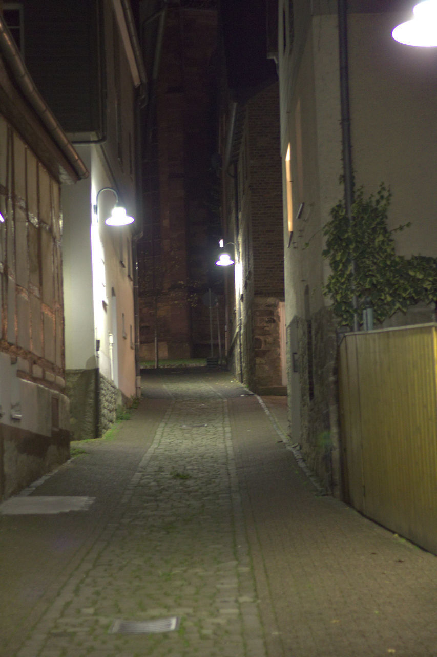 illuminated, night, the way forward, direction, architecture, lighting equipment, built structure, building, street, no people, diminishing perspective, empty, street light, building exterior, footpath, city, vanishing point, electric light, narrow, light, alley, long, electric lamp