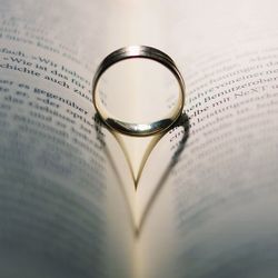 Close-up of wedding rings on book