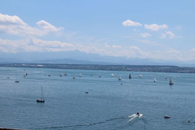 People swimming in sea against sky