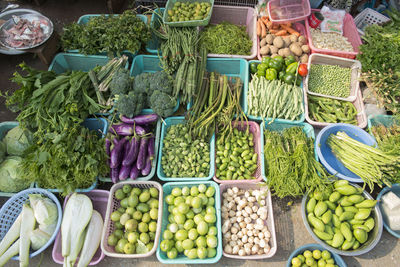 High angle view of vegetables in plastic containers at market for sale