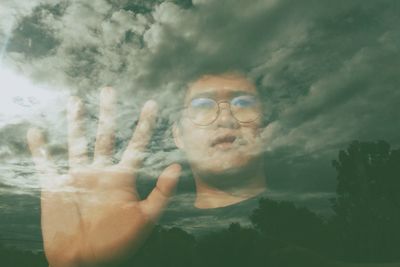 Portrait of man in sunglasses against sky