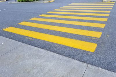 High angle view of yellow crossing sign on road