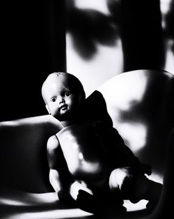 Girl sitting against black background