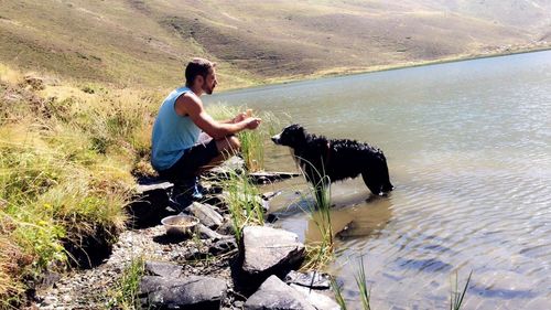 Dog standing on lake