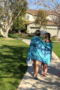 Rear view of women walking on footpath