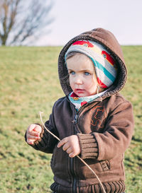 Portrait of boy standing on field