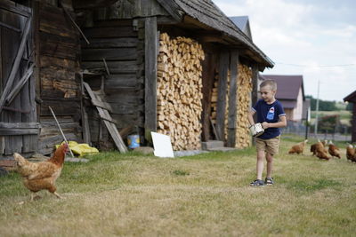 Full length of boys standing on grass