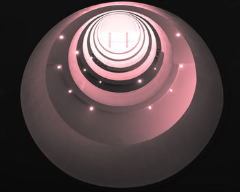 Directly below shot of illuminated spiral staircase