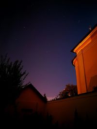 Low angle view of silhouette trees against sky at night